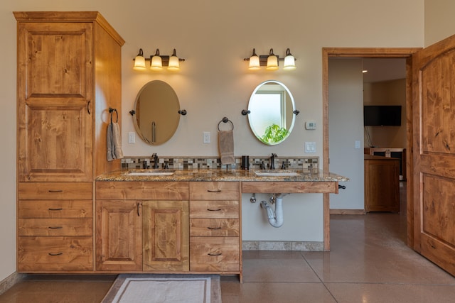 bathroom with vanity and concrete flooring