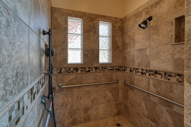 bathroom with tiled shower