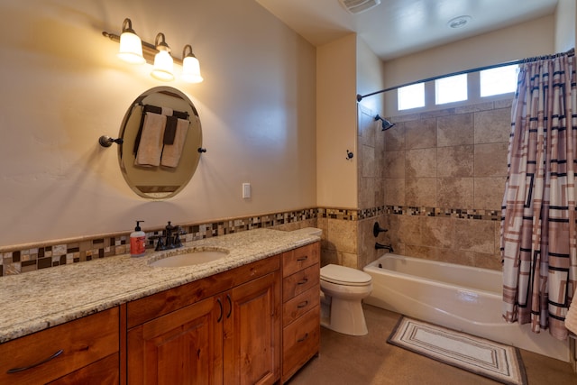 full bathroom featuring shower / bath combo, vanity, and toilet