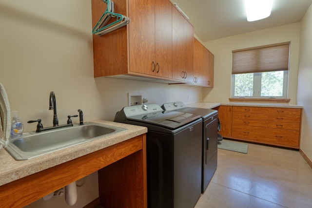 laundry area with sink, cabinets, and independent washer and dryer