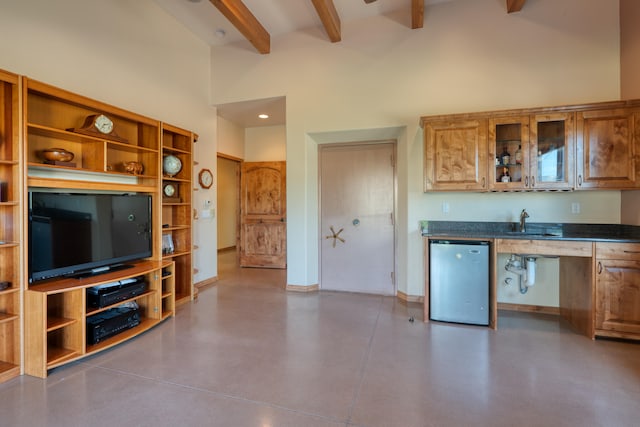 kitchen with stainless steel dishwasher, beam ceiling, sink, and high vaulted ceiling