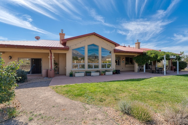 rear view of property featuring a patio area and a yard