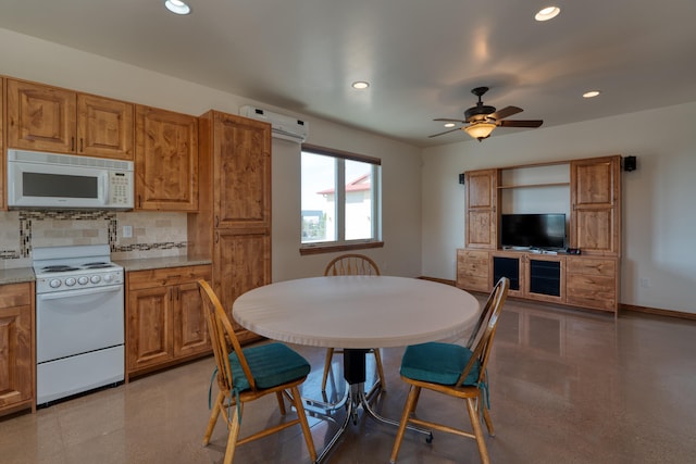 dining space with an AC wall unit and ceiling fan