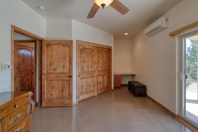 interior space featuring concrete floors, an AC wall unit, ceiling fan, and built in desk