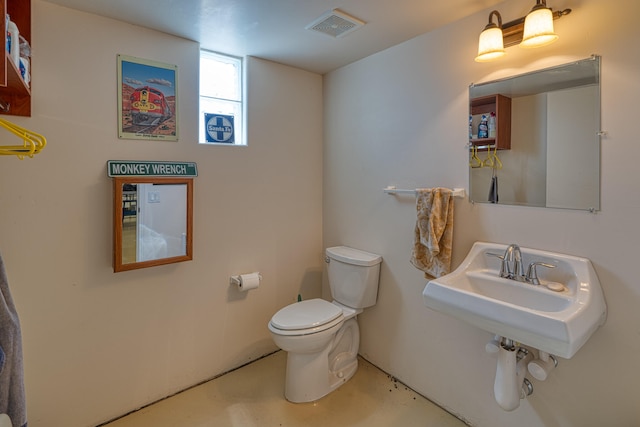 bathroom featuring toilet and concrete floors