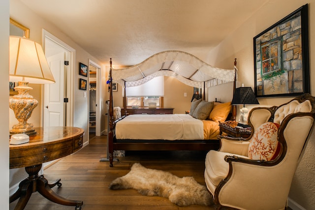 bedroom with hardwood / wood-style flooring