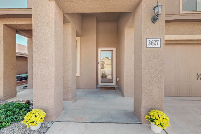 view of exterior entry with a garage