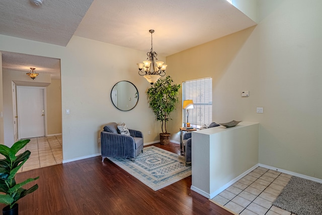 sitting room with a notable chandelier and light hardwood / wood-style flooring