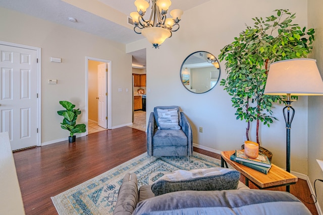 living area featuring a notable chandelier and dark wood-type flooring