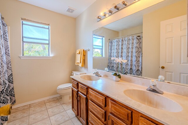 bathroom featuring tile patterned floors, vanity, and toilet