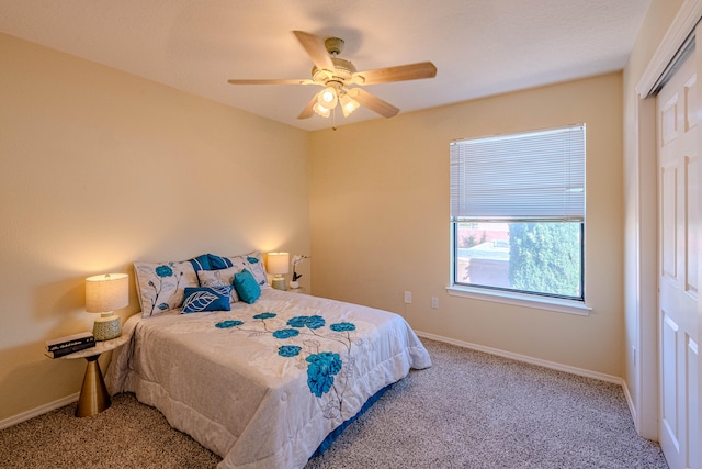 bedroom with ceiling fan, a closet, and carpet