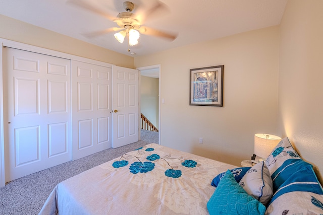 carpeted bedroom with ceiling fan and a closet