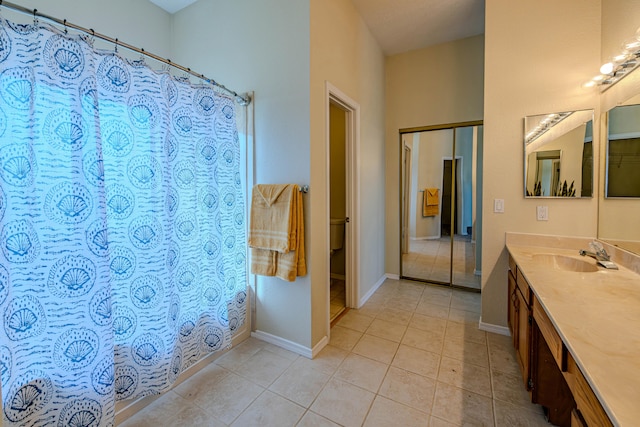 bathroom featuring tile patterned flooring, vanity, and a shower with curtain