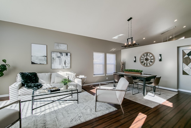 living room with wood-type flooring and vaulted ceiling