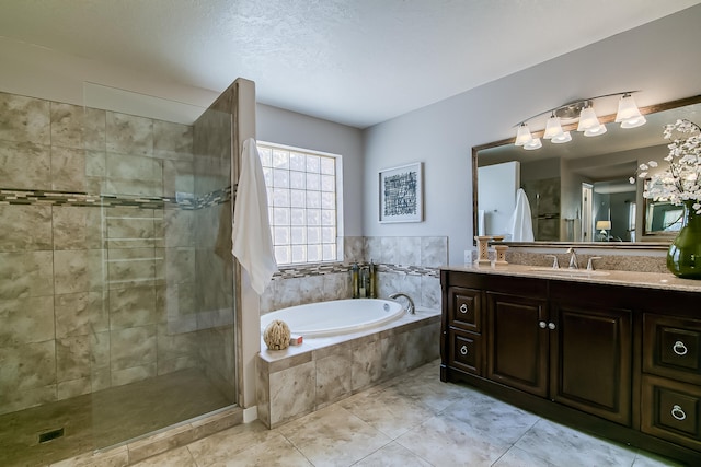 bathroom with tile patterned floors, vanity, a textured ceiling, and shower with separate bathtub