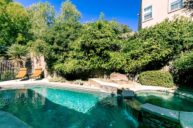 view of pool with an in ground hot tub