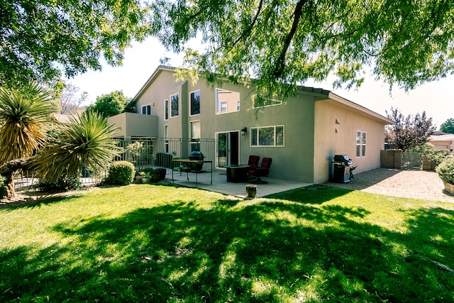 rear view of house with a patio area and a yard