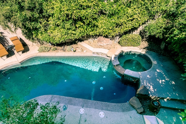 view of pool with an in ground hot tub