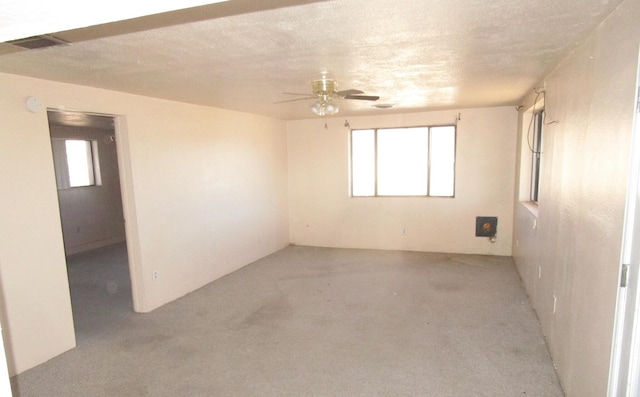 spare room with ceiling fan and a textured ceiling