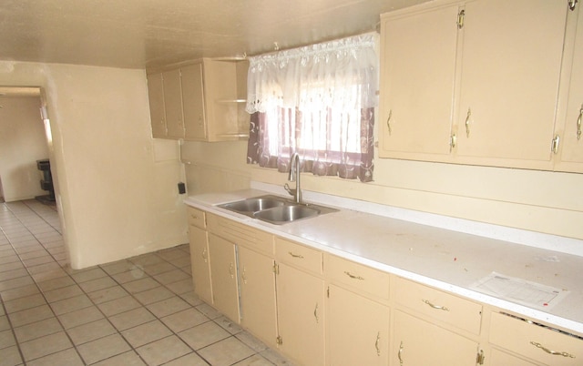 kitchen featuring light tile patterned flooring and sink