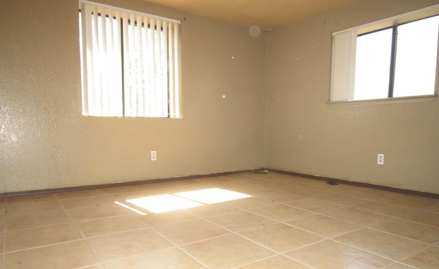 empty room with light tile patterned floors