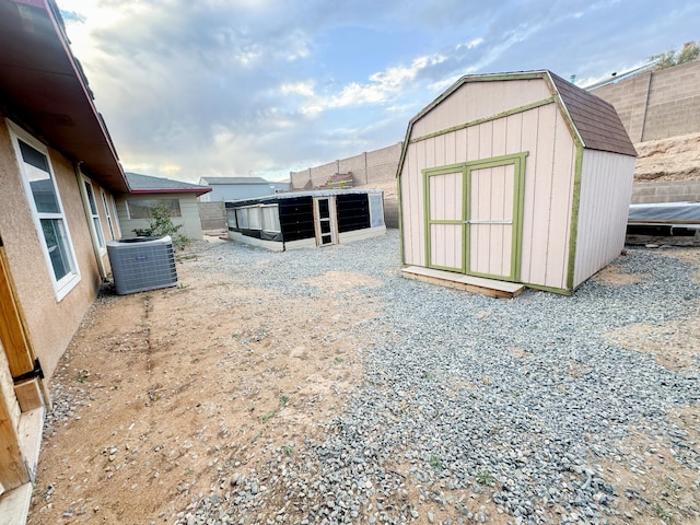 exterior space featuring central AC and a storage shed