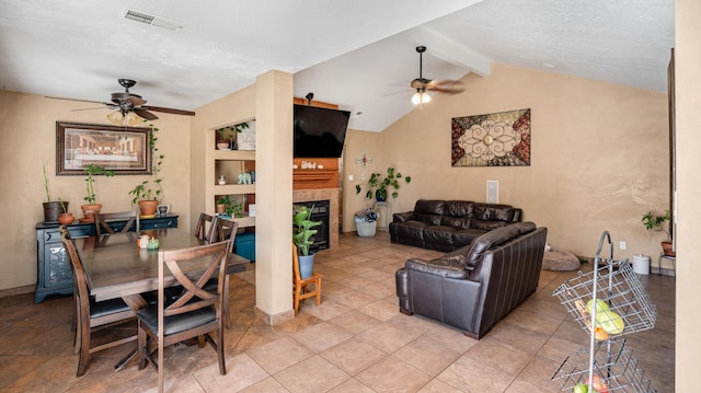 interior space with a barn door, ceiling fan, lofted ceiling with beams, and a textured ceiling