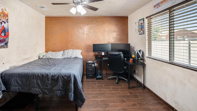 bedroom with dark hardwood / wood-style floors and ceiling fan