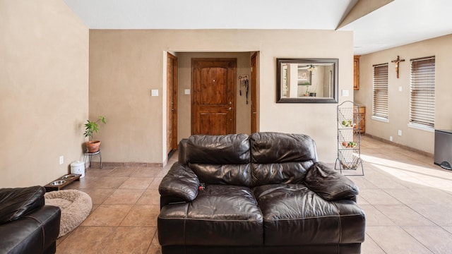 living room with light tile patterned flooring and lofted ceiling