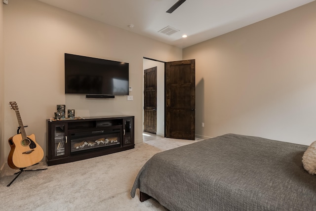 bedroom featuring light colored carpet and ceiling fan