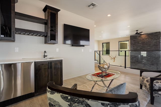 interior space with sink, light wood-type flooring, and ceiling fan