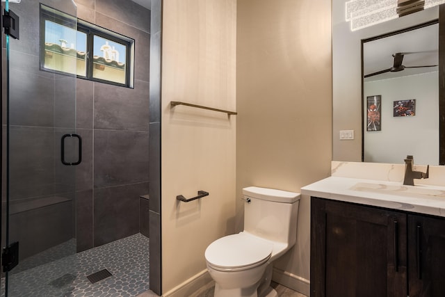 bathroom with a shower with door, vanity, and toilet