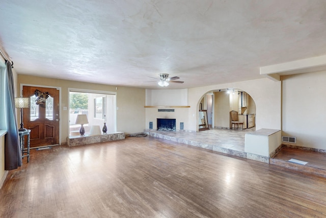 unfurnished living room with hardwood / wood-style floors and ceiling fan