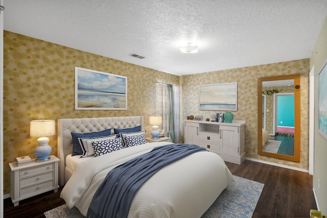 bedroom featuring dark hardwood / wood-style flooring and a textured ceiling