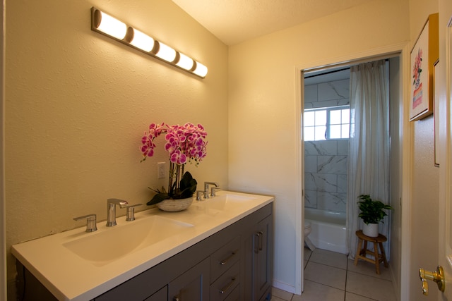 full bathroom with vanity, shower / bathtub combination with curtain, tile patterned floors, toilet, and a textured ceiling