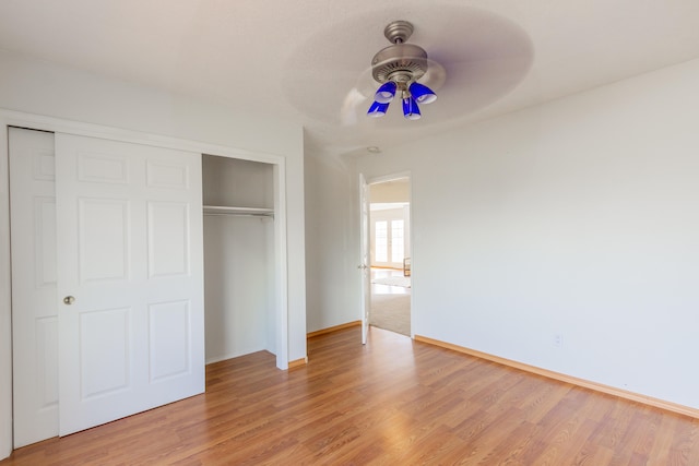 unfurnished bedroom with ceiling fan, a closet, and light hardwood / wood-style flooring