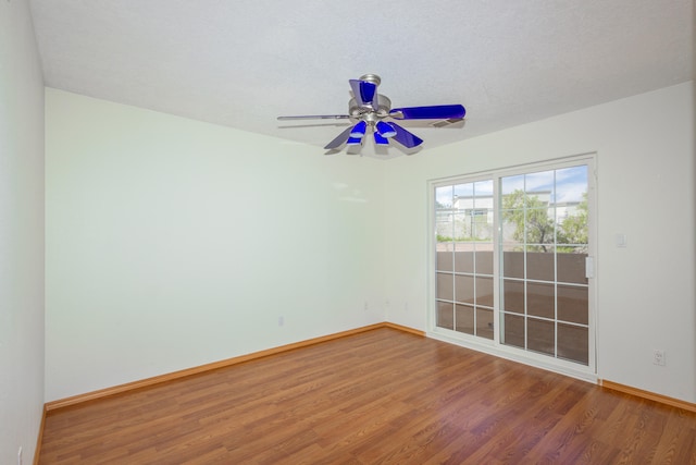 unfurnished room with ceiling fan, wood-type flooring, and a textured ceiling