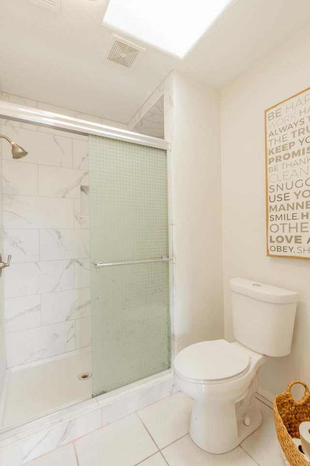 bathroom featuring an enclosed shower, tile patterned flooring, and toilet