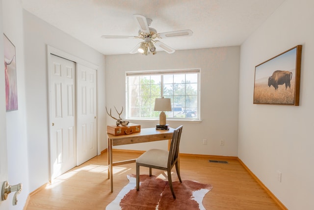 office space with light wood-type flooring and ceiling fan