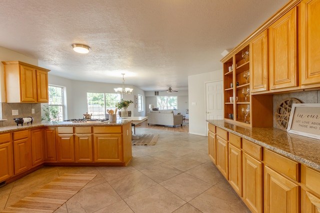 kitchen with decorative backsplash, light tile patterned floors, and a wealth of natural light