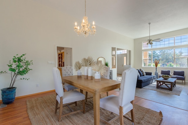 dining space featuring ceiling fan with notable chandelier and hardwood / wood-style floors