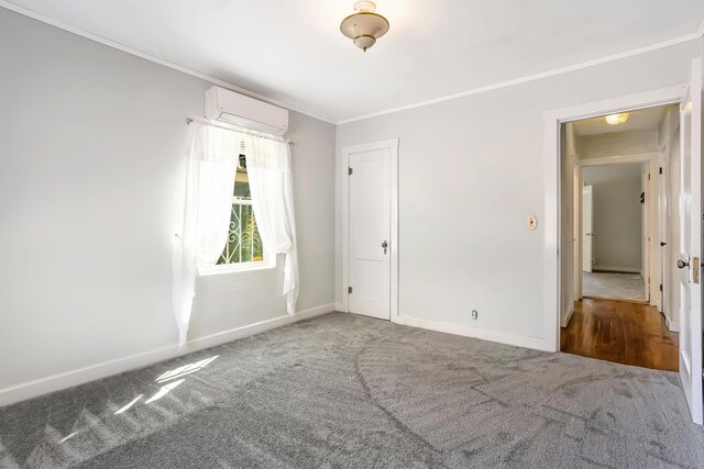 carpeted empty room with ornamental molding and a wall unit AC