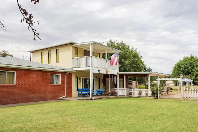 back of house with a yard, a pergola, and a patio area