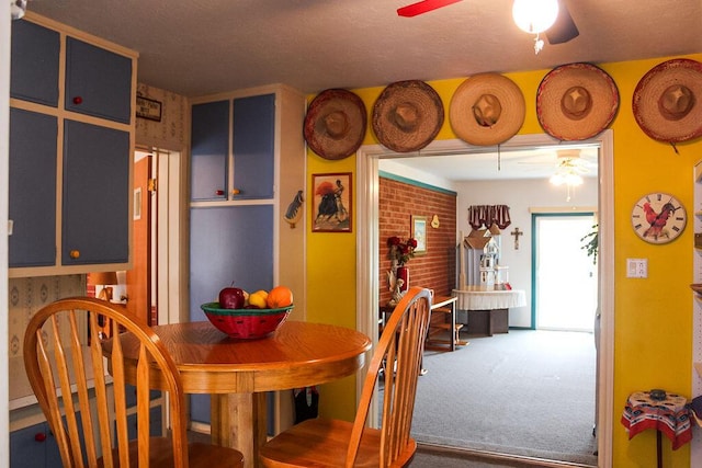 dining space featuring carpet flooring and ceiling fan