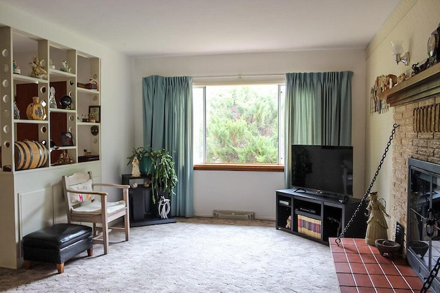 living area featuring a fireplace and carpet