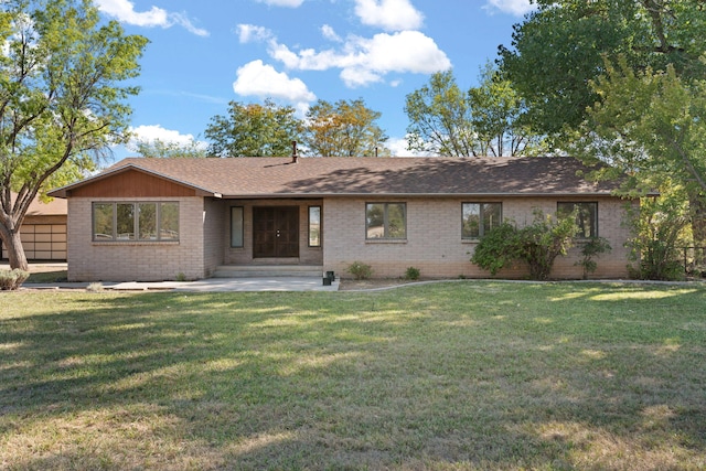 ranch-style home with a front yard and a patio area