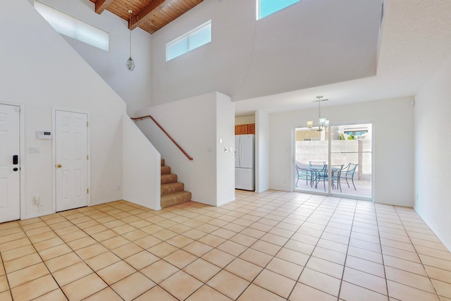 entrance foyer with wood ceiling, a notable chandelier, high vaulted ceiling, and light tile patterned floors