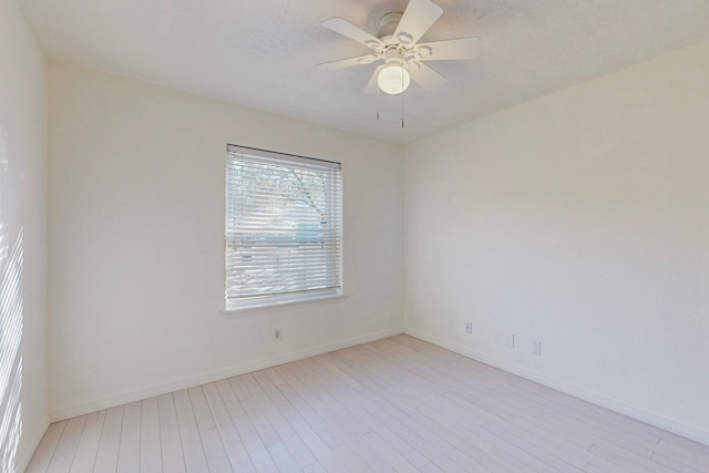 spare room with light hardwood / wood-style flooring, a textured ceiling, and ceiling fan