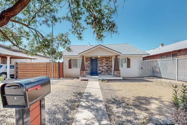 1139 Forrester Ave NW, Albuquerque, NM 87104 - view of front of property with fence, stucco siding, a porch, roof with shingles, and a gate