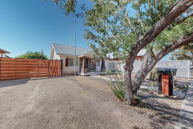 1139 Forrester Ave NW, Albuquerque, NM 87104 - view of front of house with stucco siding, a gate, and fence